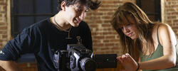 two students working on a camera together