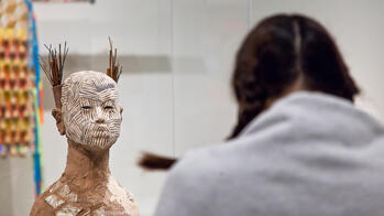 student looking at a sculpture in the risd museum
