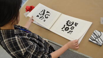 student looking at glyphs in a book
