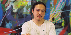 person standing in front of colorful artwork