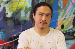 person standing in front of colorful artwork