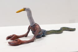 sculpture with duck head, crab claws, and snake body