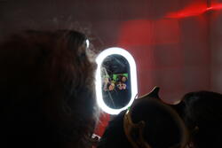 students taking selfies in a photobooth