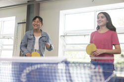 two students playing pingpong